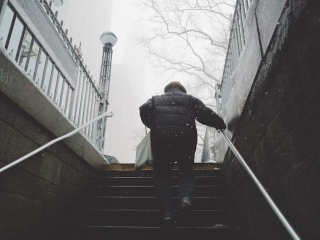 A Person Walking Up A Flight Of Stairs