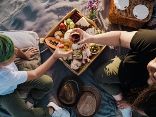 A Group Of People Sitting Around A Table With Food On It